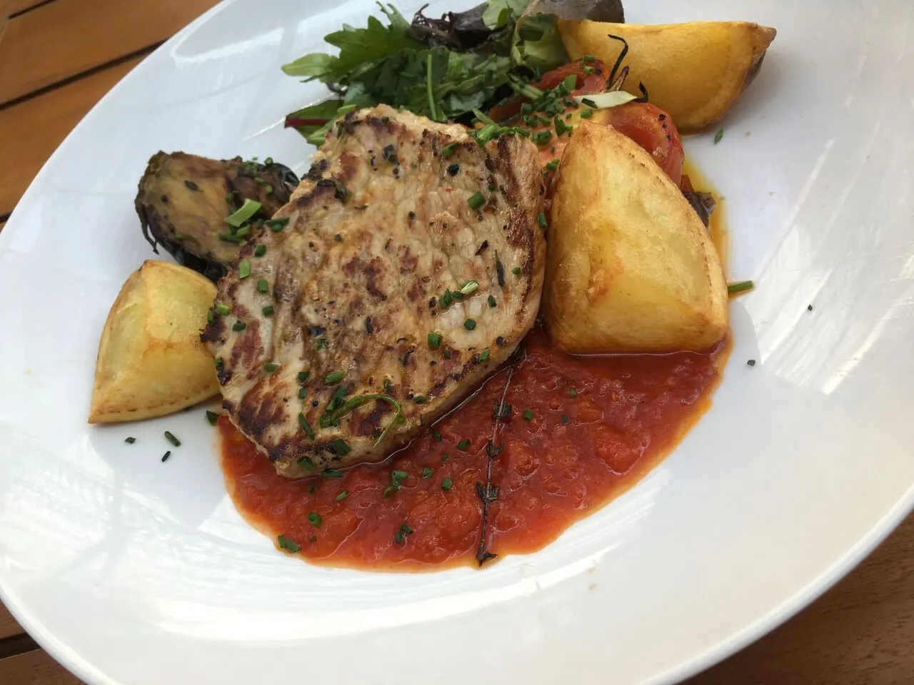 Assiette de viande grillée, pommes de terre rôties et sauce tomate